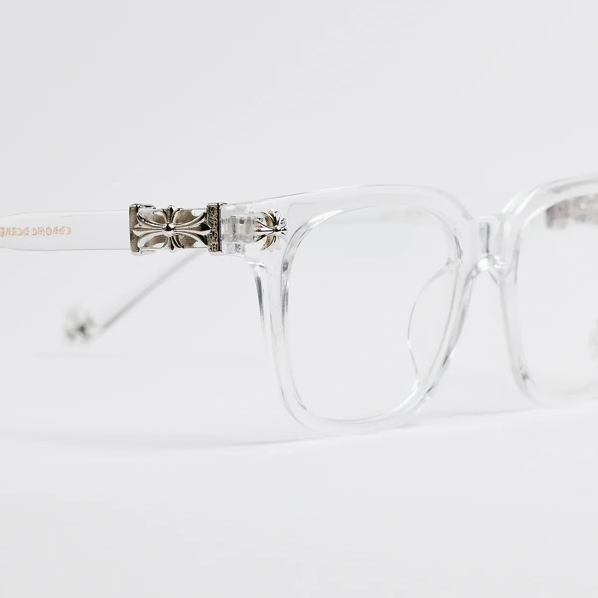 Clear eyeglasses with a decorative metal bridge on a white background