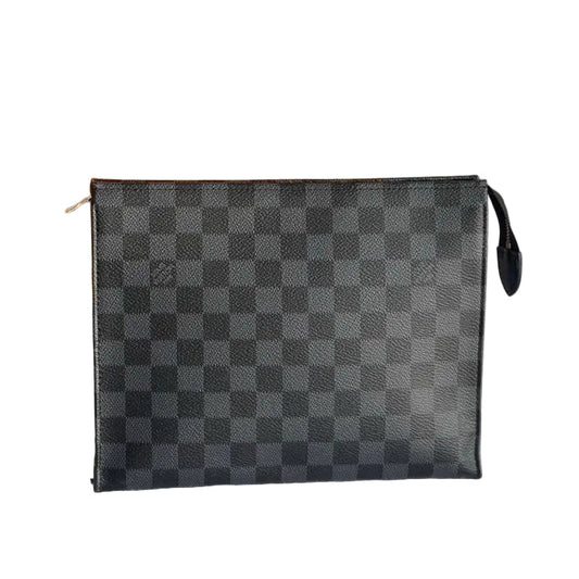 Louis Vuitton pouch with checkered pattern on a gray surface, with an orange Louis Vuitton bag in the background.