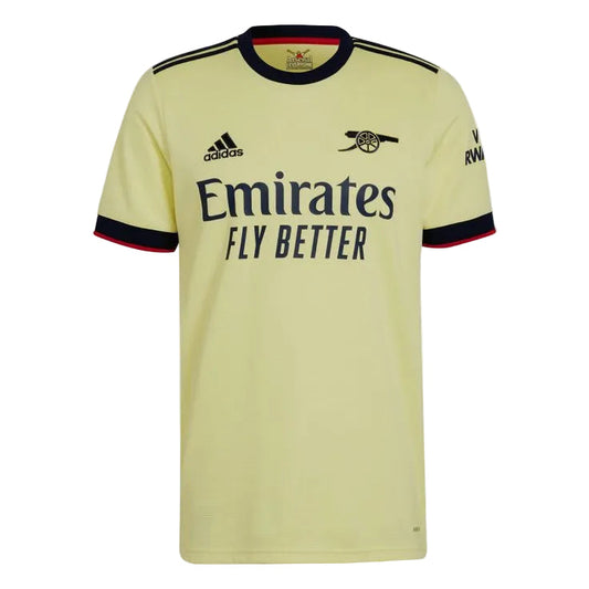 A pale yellow Arsenal home soccer jersey by Adidas, featuring the club's cannon crest, the Emirates Fly Better sponsor logo, and navy blue trim on the collar and sleeve cuffs.
