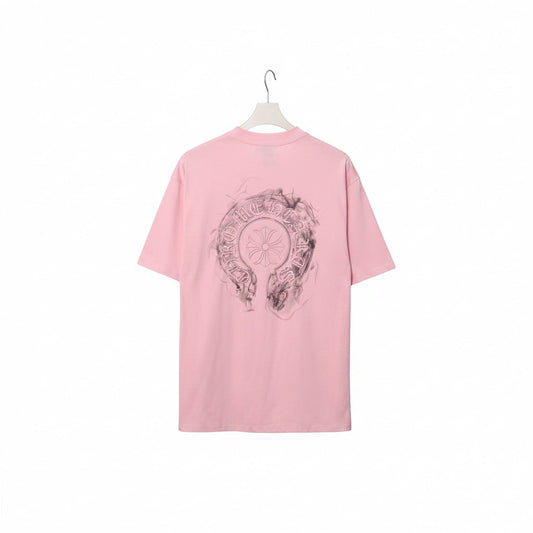Pink t-shirt with graphic design on a rack against a gray background