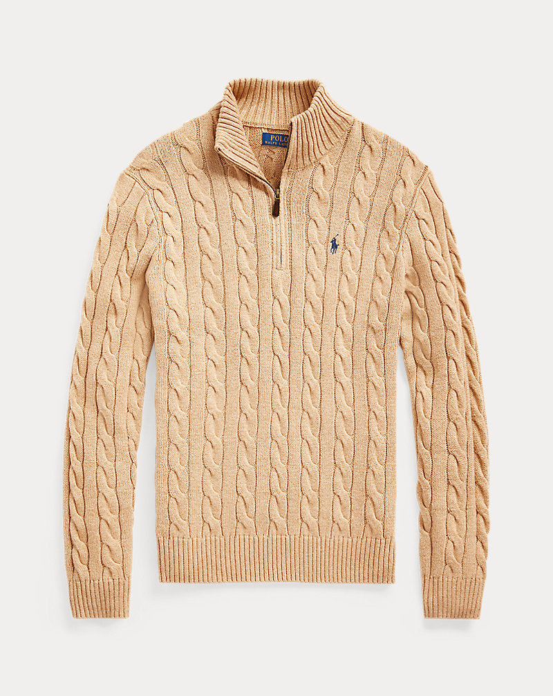 Beige cable knit sweater with a brand logo on a light beige background