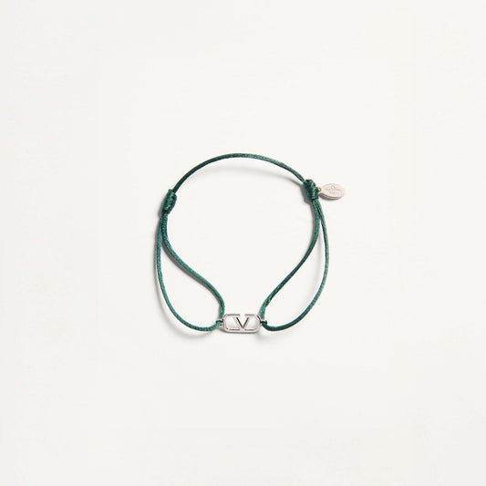 Green bracelet with a silver clasp on a white background
