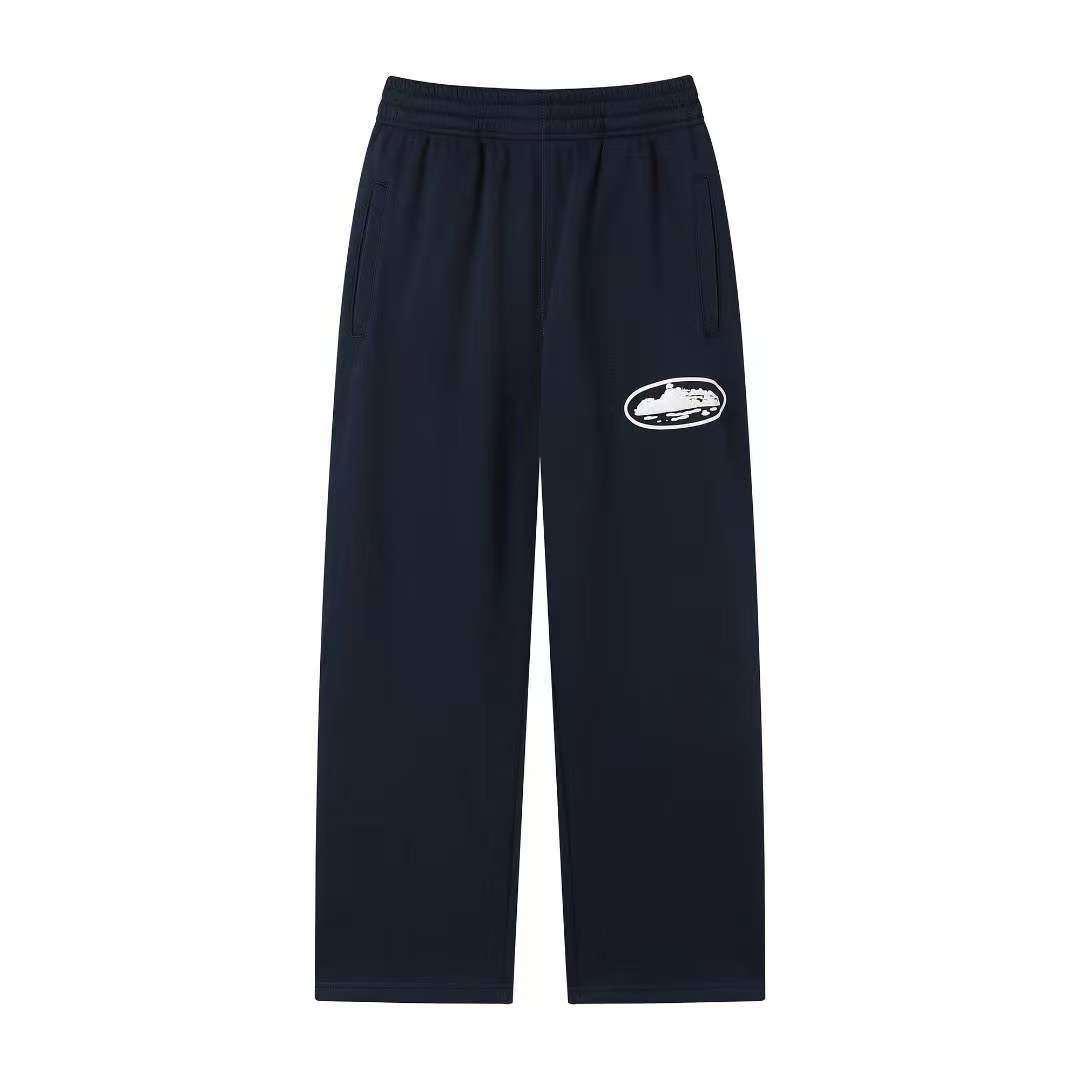 Navy blue sweatpants with a white logo on a white background