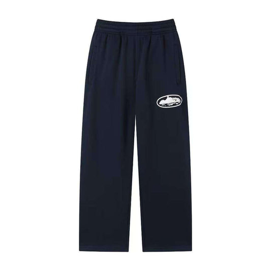 Navy blue sweatpants with a white logo on a white background